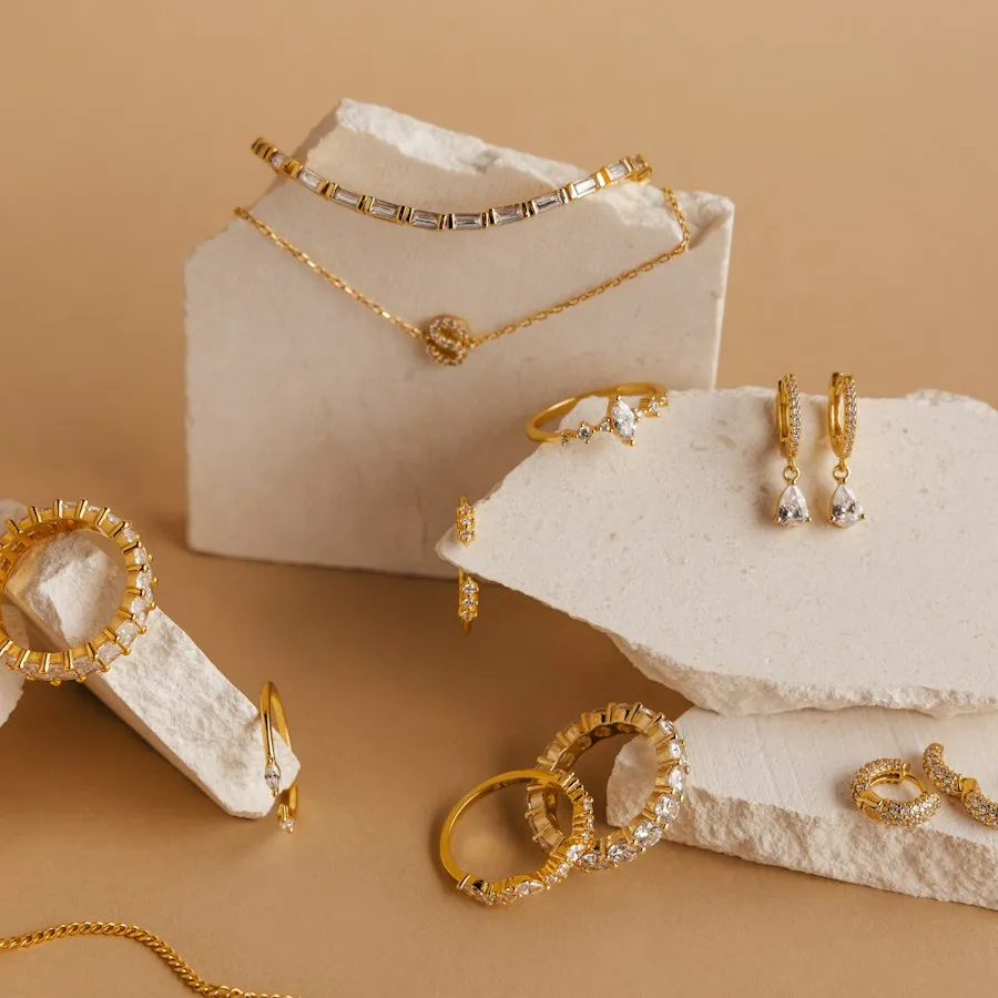 Dainty gold necklaces displayed on plaster blocks